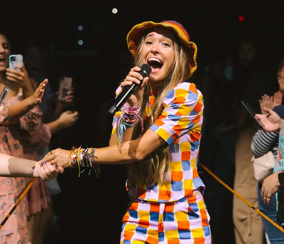 Lauren Daigle op het podium met de Kaleidoscope Tour. Vrolijke flower power-kleuren